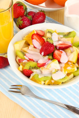 Useful fruit salad of fresh fruits and berries in bowl