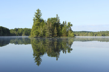 Fototapeta na wymiar Island and Reflection on the Surface of a Lake - Ontario, Canada