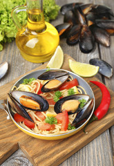 Traditional noodles with mussels on table, close up