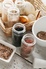 Different sea salt on wooden table, close up