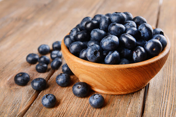 Delicious blueberries in bowl on table close-up