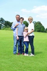 Cute family of four posing to camera