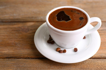 Cup of coffee on wooden background