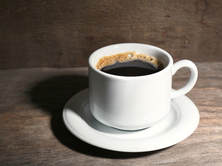 Cup of coffee on wooden background