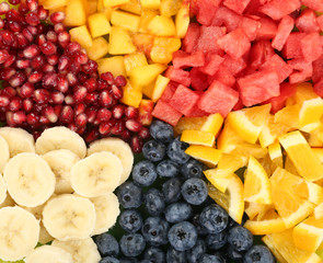 Sliced fruits on plate on wooden table