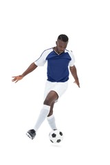 Football player in blue jersey controlling ball