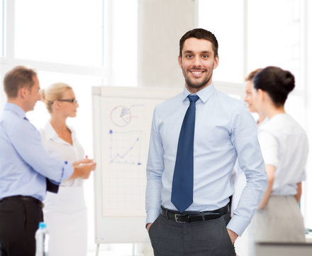 group of smiling businessmen with smartboard