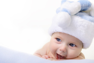 christmas cute baby boy lying on blue soft plaid like on snowdri