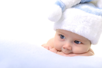 christmas cute baby boy lying on blue soft plaid like on snowdri