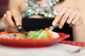 Woman eating in a restaurant closeup