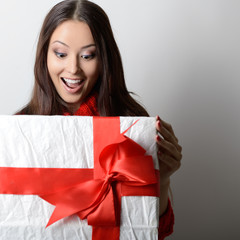 Young happy excited woman open gift box