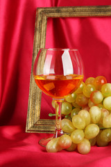 composition of frame,wine and grapes on bright background