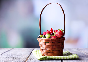 Forest berries in wicker basket,