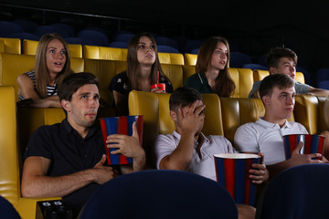 Young people watching movie in cinema