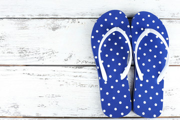 Color flip-flops on wooden background