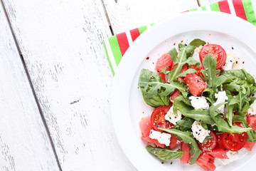 Salad with watermelon,tomatoes,  feta, arugula and basil leaves