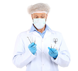 Doctor in glasses holding medical instruments isolated on white