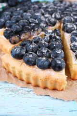 Tasty homemade pie with blueberries on wooden table