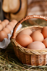 Eggs in wicker basket on table close-up