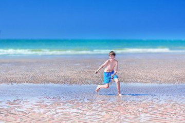 Fototapeta premium Boy running on a beach