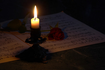 candle and music paper