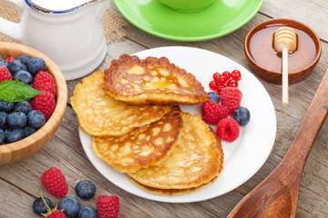 Pancakes with raspberry, blueberry, mint and honey syrup