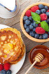 Pancakes with raspberry, blueberry, mint and honey syrup