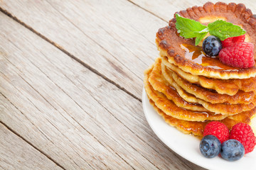 Pancakes with raspberry, blueberry, mint and honey syrup