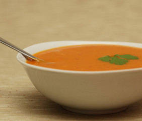Pumpkin soup in white bowl