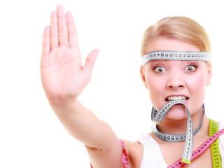 Obsessed fitness woman with a lot of colorful measure tapes