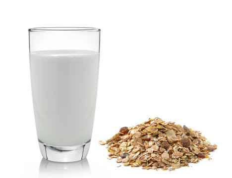 fresh milk in the glass and muesli breakfast placed on white bac