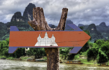 Cambodia wooden sign with a forest on background