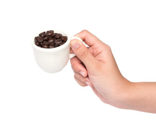 female hand hold cup of coffee beans isolated on white backgroun