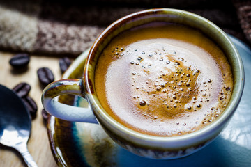 Cup of espresso with coffee beans