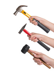 woman's hand holding three hammer on white background