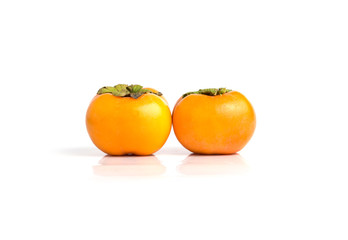Hand holding ripe persimmon isolated on a white background
