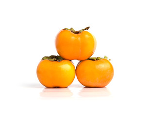 Hand holding ripe persimmon isolated on a white background
