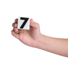Hand holind colorful plastic numbers on a white background