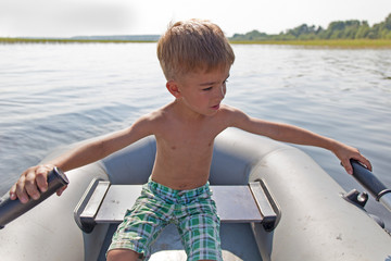 child in an inflatable boat for rowing