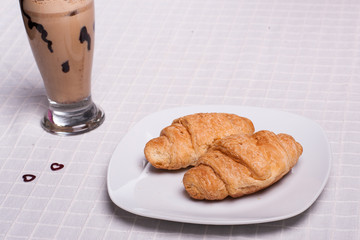 two croissant and one coffee at breakfast