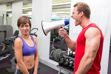 Foto op Canvas Personal trainer shouting at client through megaphone © WavebreakMediaMicro