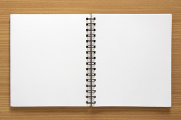 blank spiral notepad on wood background