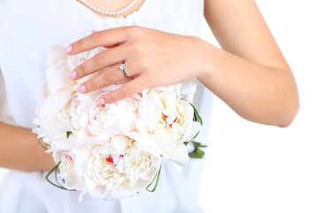 Bride holding wedding bouquet of white peonies, close-up