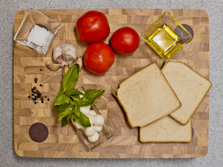 ingredients for making toast with tomato and rosemary, top view background