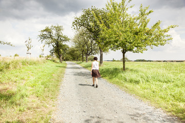 Woman taking a walk on the dirt road