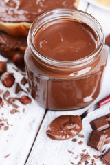 Sweet chocolate cream in jar on table close-up