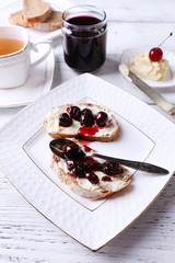 Fresh bread with cherry jam and homemade butter