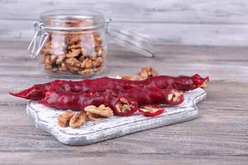 Tasty oriental sweets (churchkhela) and fresh nuts in glass