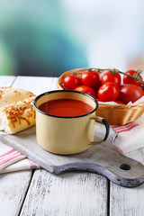 Homemade tomato juice in color mug, bread sticks, spices and