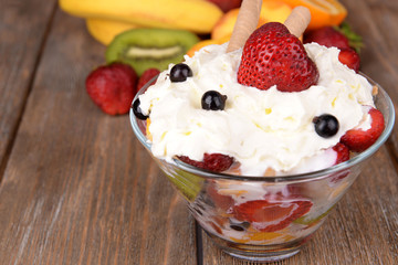 Fresh fruits salad with ice cream in bowl and fruits